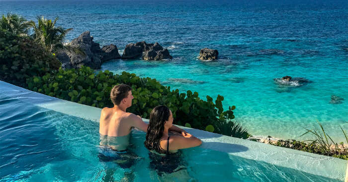 couple in a swimming pool with a view