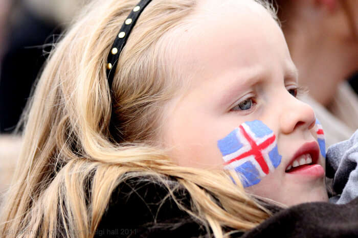 A girl flaunting Iceland National flag on her cheeks