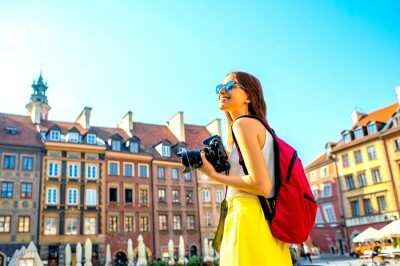 Girl with a camera in old town of Warsaw