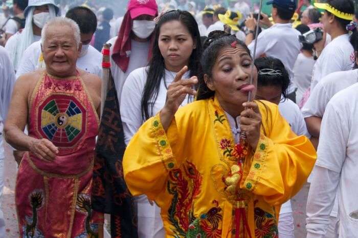 Woman piercing her tongue