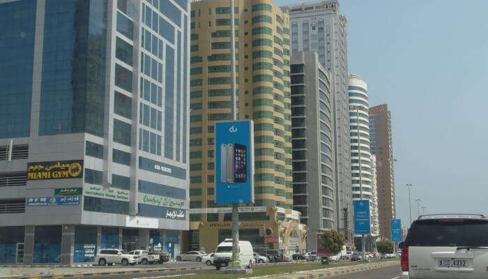 a view of the city with tall building and vehicles