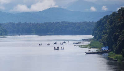 view of boats on a river and mountains on backdrop