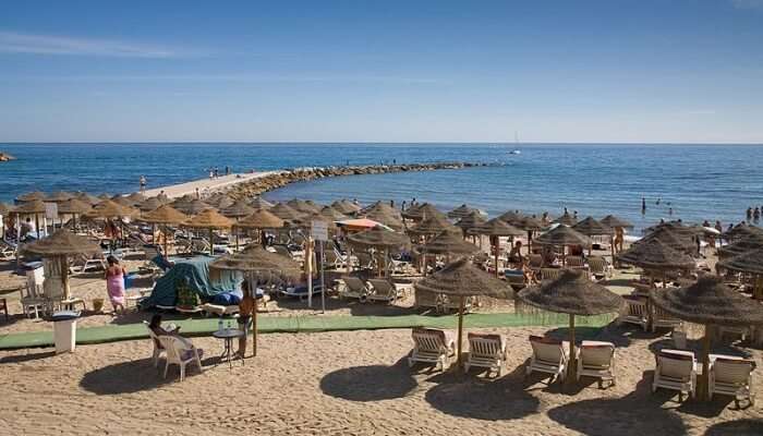 Costa Del Sol Beach contains the white sand covering the entire seashore and attracts many tourists in Spain.