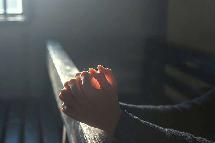 A person praying at the St. John's Anglican Cathedral in Napier