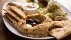 turkish starter served on a plate with dips and garnishing