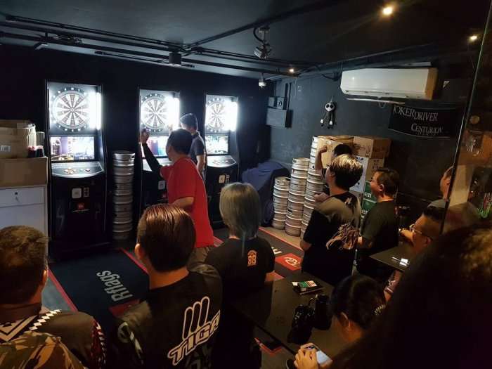 people playing darts in bar one