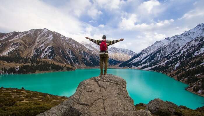 man standing near Almaty lake 