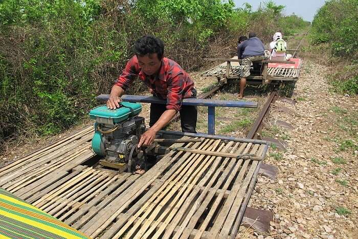 person pulling a bamboo train
