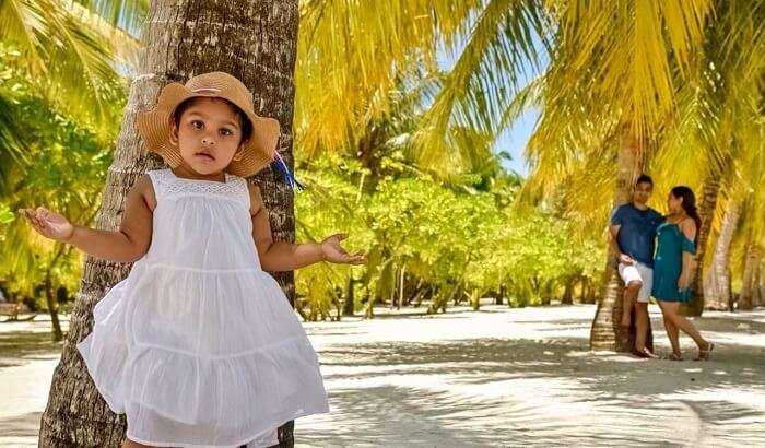 Standing near coconut palm tree