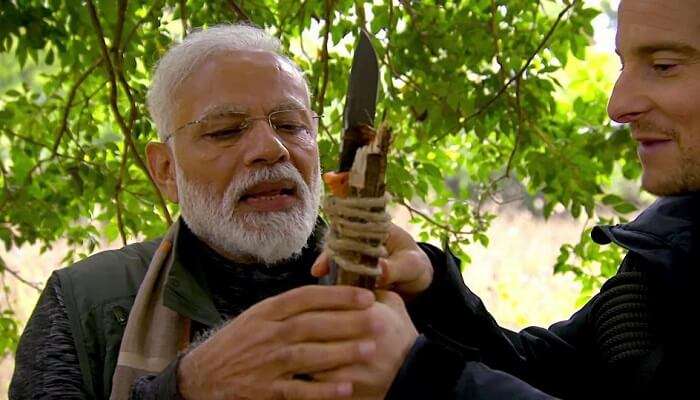 narendra modi and bear grylls holding a spear