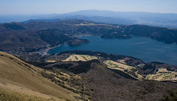 aerial view of a scenery with river and green mountains