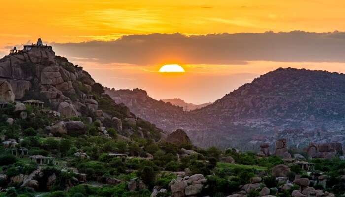 sun setting behind the ruins