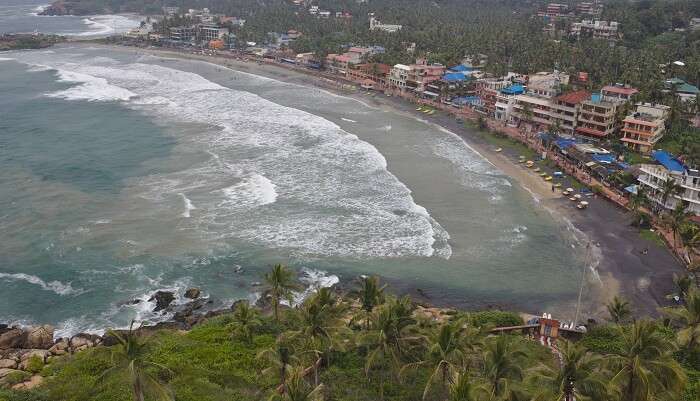 A breathtaking view of sea in Kovalam surrounded by lush greenery