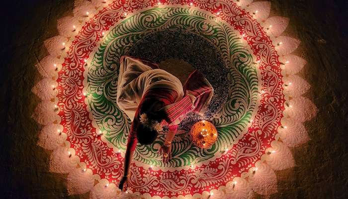 Woman lighting the candles for the Festival of Lights in India