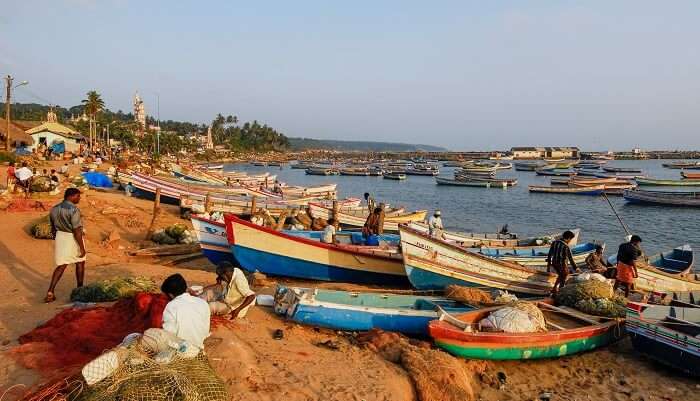 Unidentified Indian fishermen check their boats