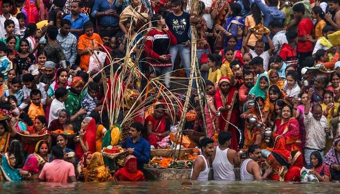 Priests carry the idols of Gods and Goddesses in a boat in the river Ganga on the occasion of Kartik Purnima