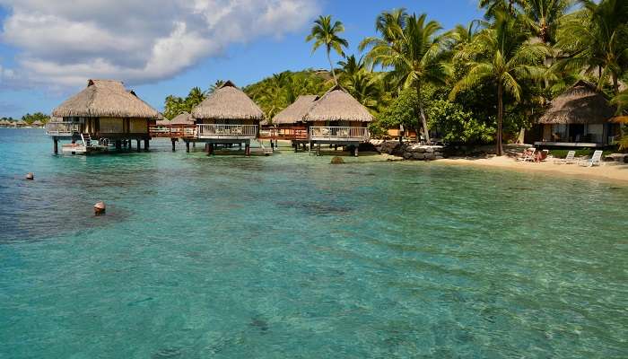 cottages on a beach at one of the Lakshadweep hotels