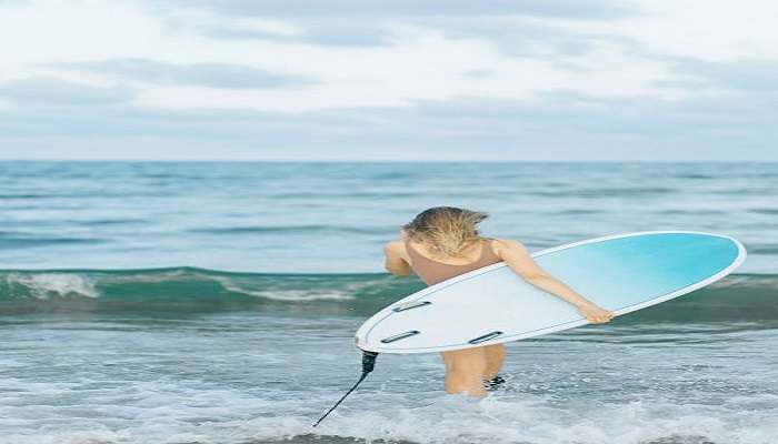 Enjoy surfing in beach in India.