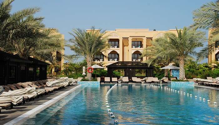 an indoor pool with personal cabanas in the best resort in Bangalore for couples.