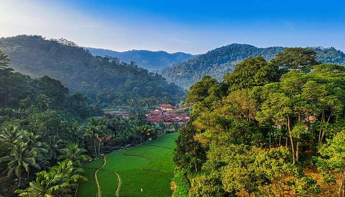 A Village Surrounded by Hills and Trees