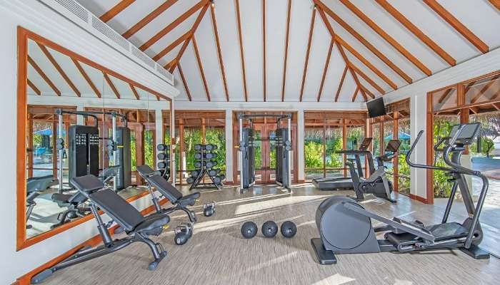 A well-equipped gymnasium at Naladhu Private Island Maldives