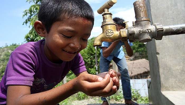 boy drinks from a tap