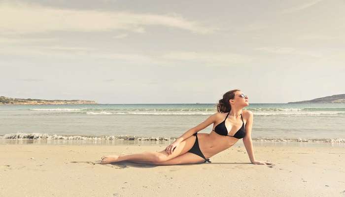 a lady wearing bikinis at beach