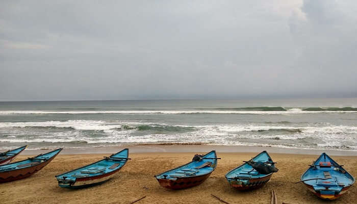 A picturesque view of boats at Gopalpur Beach, one of the best places to visit in Gopalpur