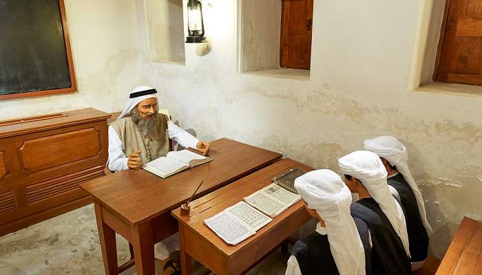 A religious teacher teaching the pupils in the first school of Dubai, now Al Eslah School Museum, one of the best museums in Sharjah.