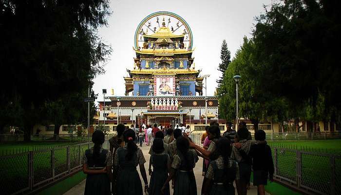 A view of the interiors of the Bylakuppe monastery with mammoth statues of three Buddhas in Gold decoration, Places To Visit Near Mysore Within 100 Kms