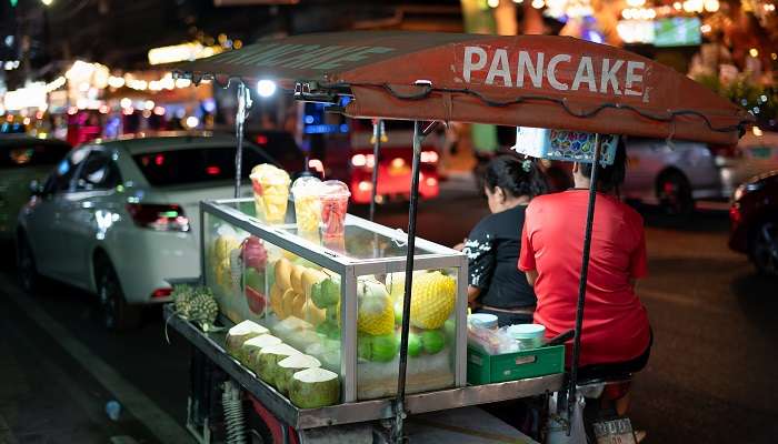 Bustling street market with colourful stalls and lively atmosphere in Phuket.