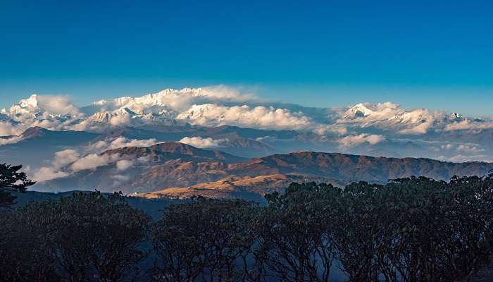 Enjoy captivating views of Sandakphu Gurdum, amidst the towering peaks while trekking near Kolkata