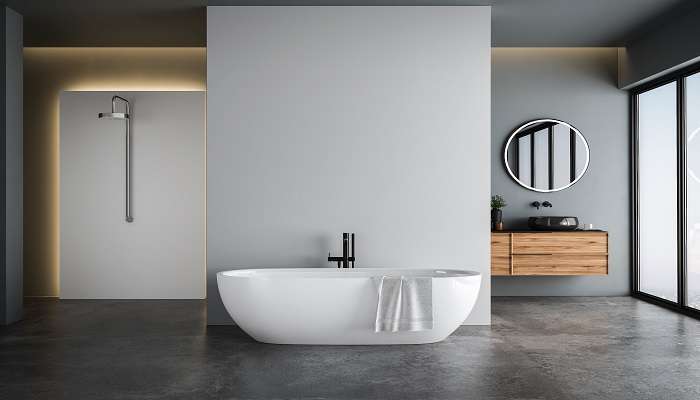 A white bathtub in a modern bathroom of Ashtamudi Resorts