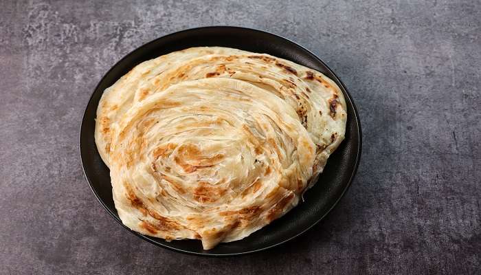 Malabar Paratha served with Chicken Curry is the local cuisine of Kerala