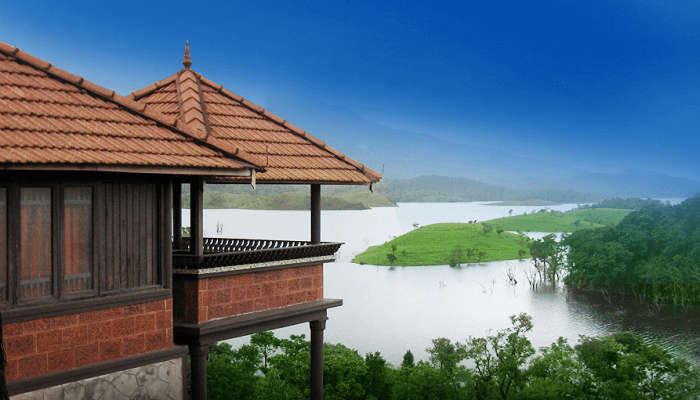 a lush greenery outside the loghut room at Banasura Island Resort