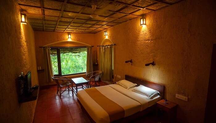 relax in the mini earth rooms of the resort having queen-sized bed.