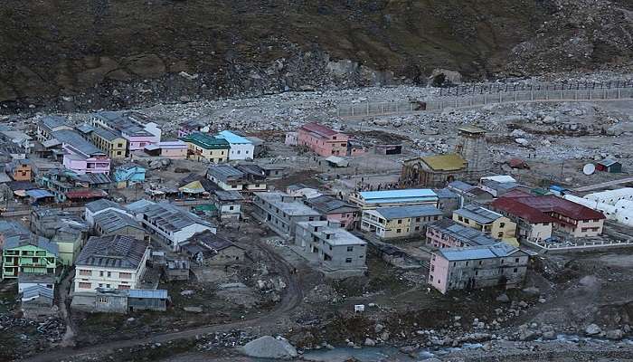 Image of a Kedarnath temple covered in orange and yellow flowers