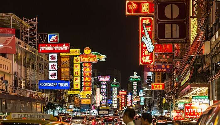 Vibrant evening scene in Chinatown Bangkok in February: bustling streets, colourful lanterns, and exotic cuisine