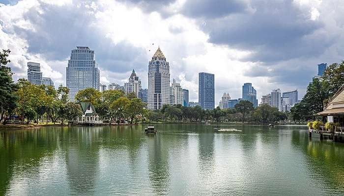 Lush Lumphini Park, Bangkok in February, with vibrant foliage and serene lakeside vistas, captivates visitors.