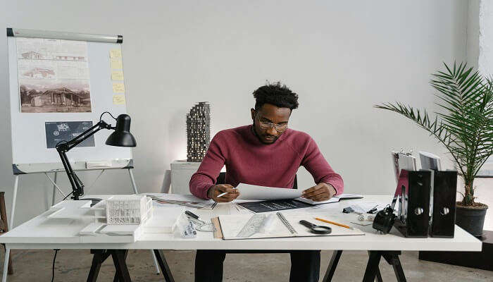 A man working on a table in a hotel room