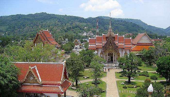 Wat Chalong Buddhist Temple's opulent golden details and majestic decorations under sunlight.