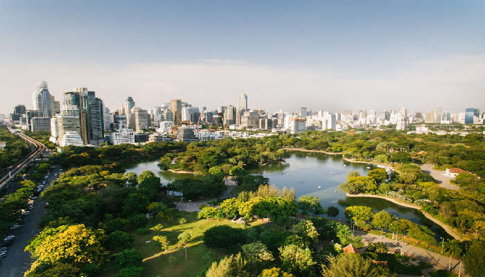 Lush Lumphini Park, Bangkok in February, with vibrant foliage and serene lakeside vistas, captivates visitors.