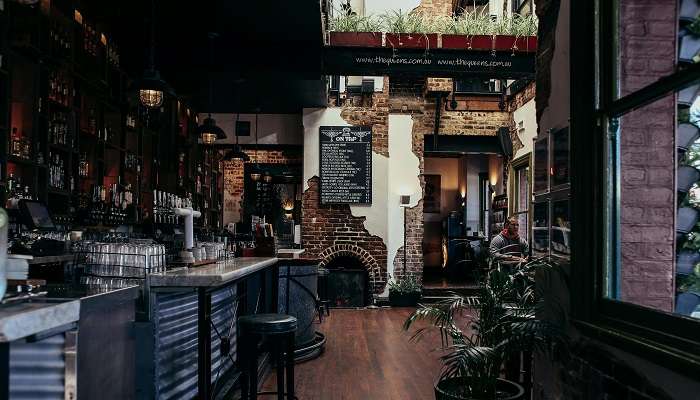 Interior of sports bar with television and beer taps, Pubs in Ballina