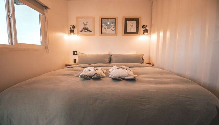 A warm looking bed in a hotel room 