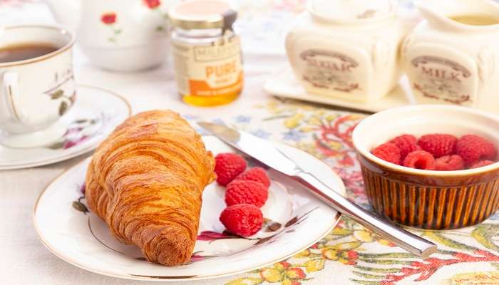 Freshly baked croissant with raspberry