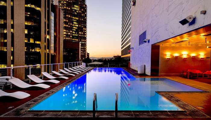 White Sun Loungers Beside Pool