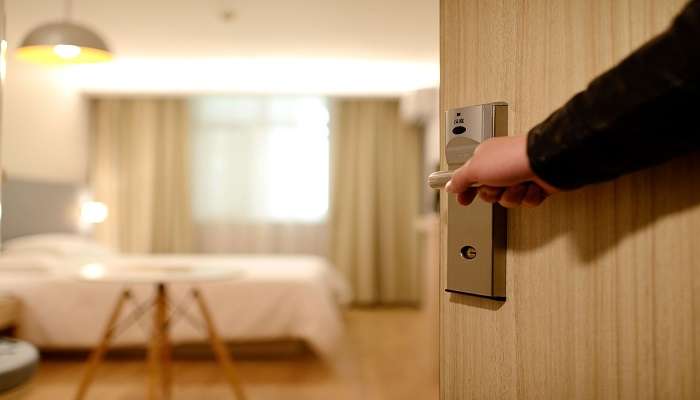 A hotel staff entering a room, one of the top rated Hotels In Guindy  