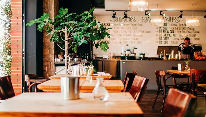 Tables and Chairs with Menu on Wall