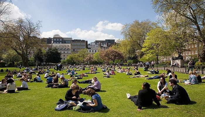 People enjoying the spring sun at the Lincoln Inn Fields near the British Museum.