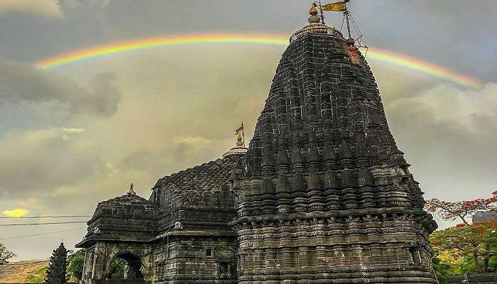 The jaw dropping view of a rainbow casted above the Trimbakeshwar temple